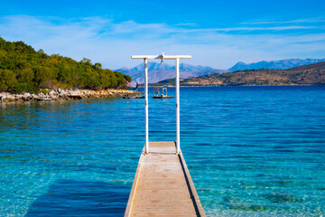 Wooden pier on the beach in Ksamil in Albania