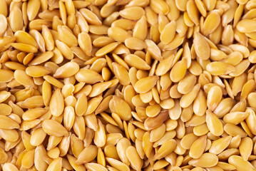 Texture of  macro photo of raw  golden flax seeds texture for superfood and diet product concept. Food background of flaxseed