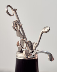 spare keys and other clarinet parts are arranged as a metal bouquette inside a clarinet bell
