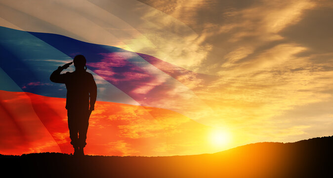 Silhouette of russian soldier in uniforms on background of sunset sky with the Russian flag. Military recruitment concept.