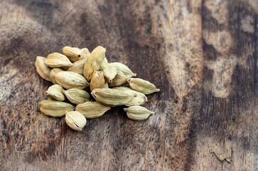 Closeup of Dry Cardamon Pods or Cardamom Isolated on Wooden Background With Copy Space