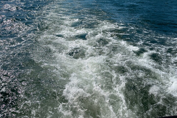 Fototapeta na wymiar Powerful waves shot from a fast moving boat