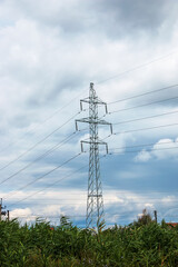 Obraz premium High voltage post against clear blue sky.