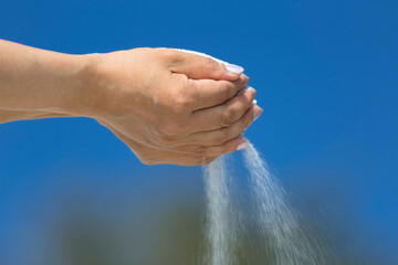 Blowing sand out of hand