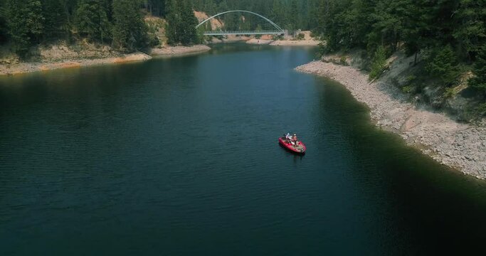 Sweeping drone shot of a bridge overlooking a lake.