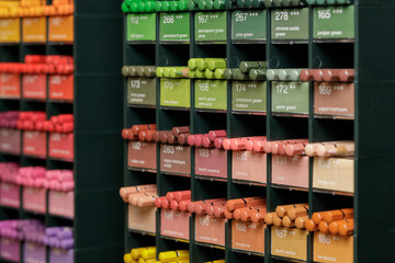 Colorful background with multi-colored pencils placed on rack in art and crafts store
