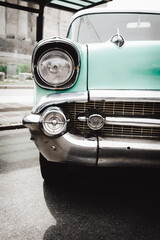 Detail of the headlight or left front light of a vintage car from the 50s. Mobility concept, Combustion car.