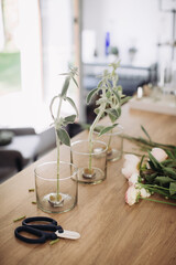 A florist makes a stylish flower arrangement on Kenzan.