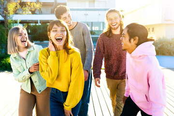 happy group of multiracial friends smiling outdoors on the street -cheerful young people laughing...