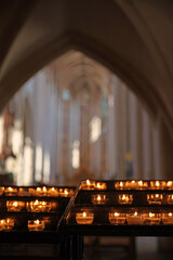 Burning candles in catholic church in the evening candle fire