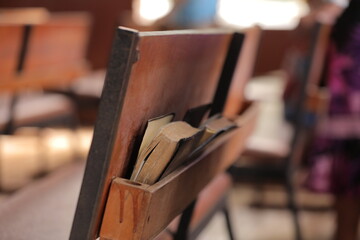Close up of books for prayers on the back side of a desk in a church...