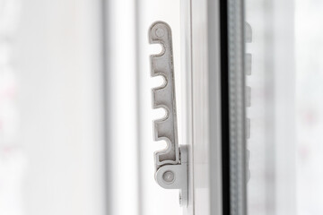 Close-up shot of a double-glazed plastic door frame, one-way balcony window handle,PVC window latch...