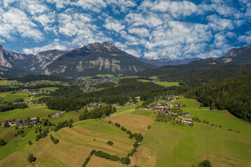 Aerial view of the village, fields and forest in mountains Alps Austria