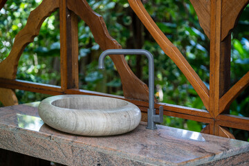 Natural organic stone sink washbasin in the summer tropical garden on Bali island in Indonesia