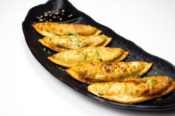Fried Dumplings on a black plate