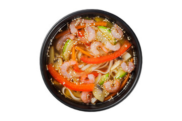 Instant soup, noodles wok, with vegetables, herbs and sesame. In a black round plate. On a white background.