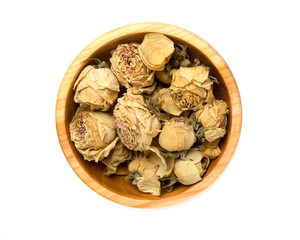 Pink dried rose buds in wooden bowl isolated on white, top view