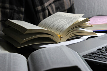 Man reading and studying on a home desk set up 