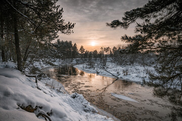 Zimowy zachód słońca nad rzeką wartą 