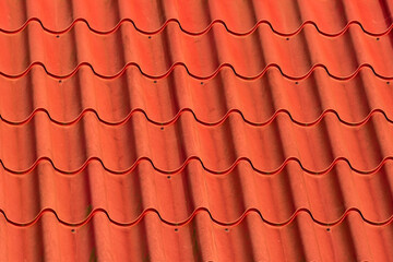 Red plastic roof tiles arranged geometrically