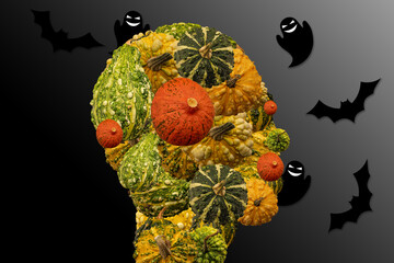 Head of a person made of decorative and halloween pumpkins with flying ghosts and bats around. Halloween symbols. Darkness surrounding.