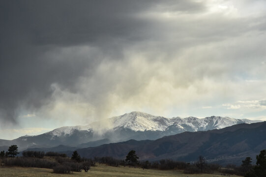 Pikes Peak Mountain with a dark cloud above