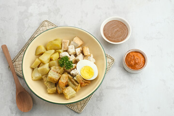 Batagor, Indonesian food made from fried fish dumpling, tofu, egg and potatoes with peanut sauce. 
