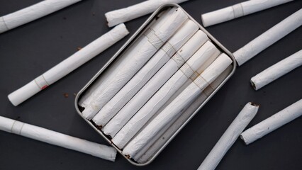 Many cigarettes stack on the table, a box of cigarettes. Unhealthy lifestyle concept and Drugs are...