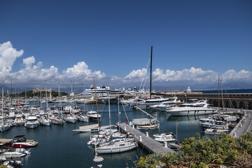 Fototapeta na wymiar View of the Port Vauban in Antibes with moored sailboats and luxury yachts on the French Riviera in sunny weather. Antibes, Alpes-Maritimes, France. 