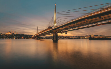 Istanbul metro bridge view with a long exposure photography sunset lights on horizon and old city at background