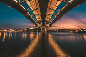 Istanbul metro bridge view with a long exposure photography sunset lights on horizon and old city at background