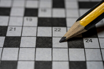 Crossword puzzle and pencil close up. High quality photo