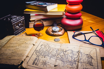 old portugal map books and glasses above a wood table drinking sweet wine from oporto