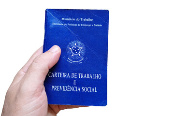 Man's hand holding Brazilian Work Card isolated on white background. Written in Portuguese Federative Republic of Brazil, Ministry of Labor. Work and Social Security card. Brazilian work concept.