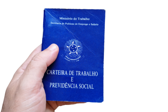 Man's hand holding Brazilian Work Card isolated on white background. Written in Portuguese Federative Republic of Brazil, Ministry of Labor. Work and Social Security card. Brazilian work concept. - Powered by Adobe