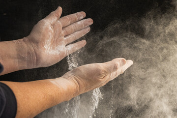 Fototapeta na wymiar hands of unrecognizable person handling flour