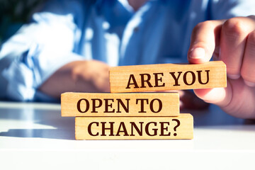 Wooden blocks with words 'ARE YOU OPEN TO CHANGE?'.