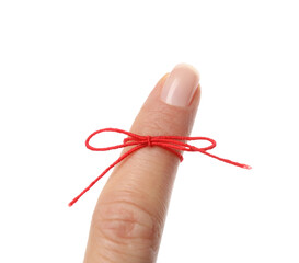 Woman showing index finger with tied red bow as reminder on white background, closeup