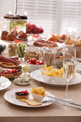 Variety of snacks on wooden table in buffet style indoors