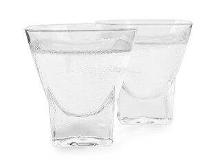 Vodka in shot glasses on white background