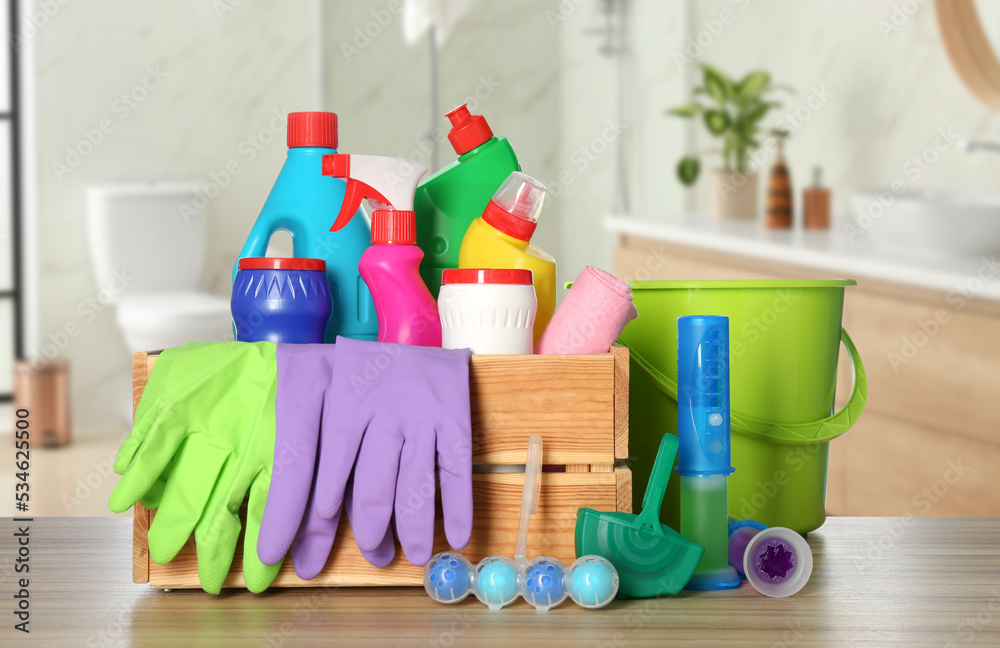 Wall mural Different toilet cleaning supplies on wooden table in bathroom