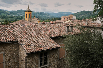Fototapeta na wymiar Scenic view of church tower, rooftops and surrounding hills in Brisighella, Emilia-Romagna, Italy