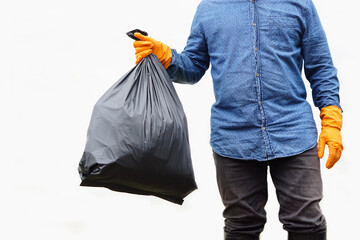 Closeup  man holds black plastic bag that contains garbage inside. White background. Concept : Waste management. Environment problems. Daily chores. Throw away rubbish . 