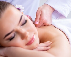 Woman during massage session in spa