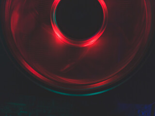 Red light of computer fan close up. cooler in action with leds. abstract background. power in motion concept