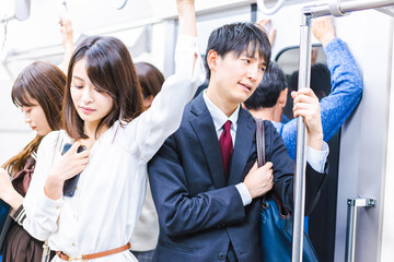 Business people commuting on crowded trains