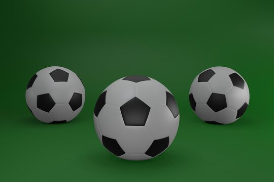 Three soccer balls isolated on green background