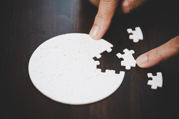Business woman person hand with puzzle piece idea for strategy and solution. Closeup part of two...