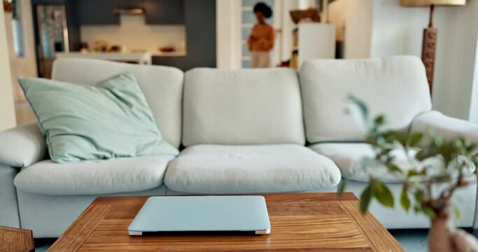 Black woman, laptop and movie streaming on sofa in house or home living room after busy work day. Relax, internet show and communication technology for social media news, email or digital website iot