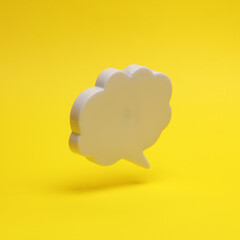 Speech bubble floating in the air on a yellow background with a shadow. Creative idea. Minimal concept. Levitating objects